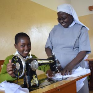 Anisia with Sisters showing in tailoring activities
